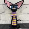 Handmade crochet black sphynx cat plush wearing glasses and a purple and yellow striped sweater
