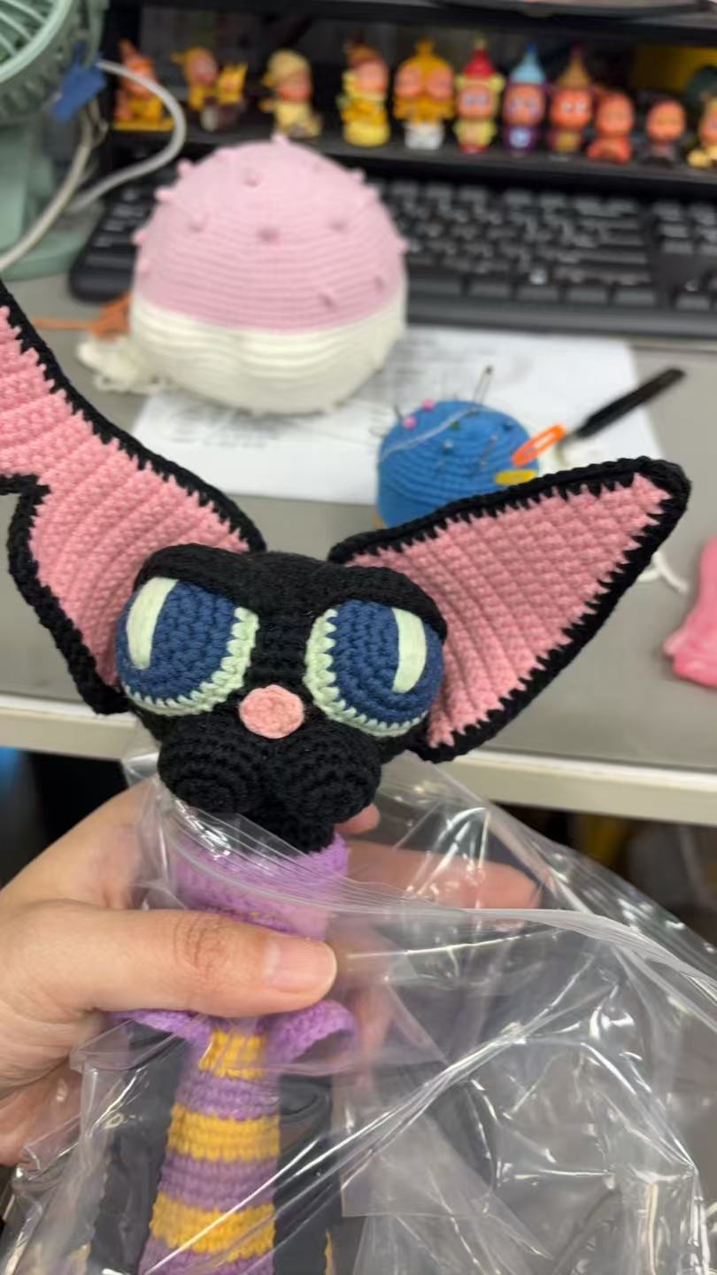 Crochet cat doll in progress on a Runoo work table